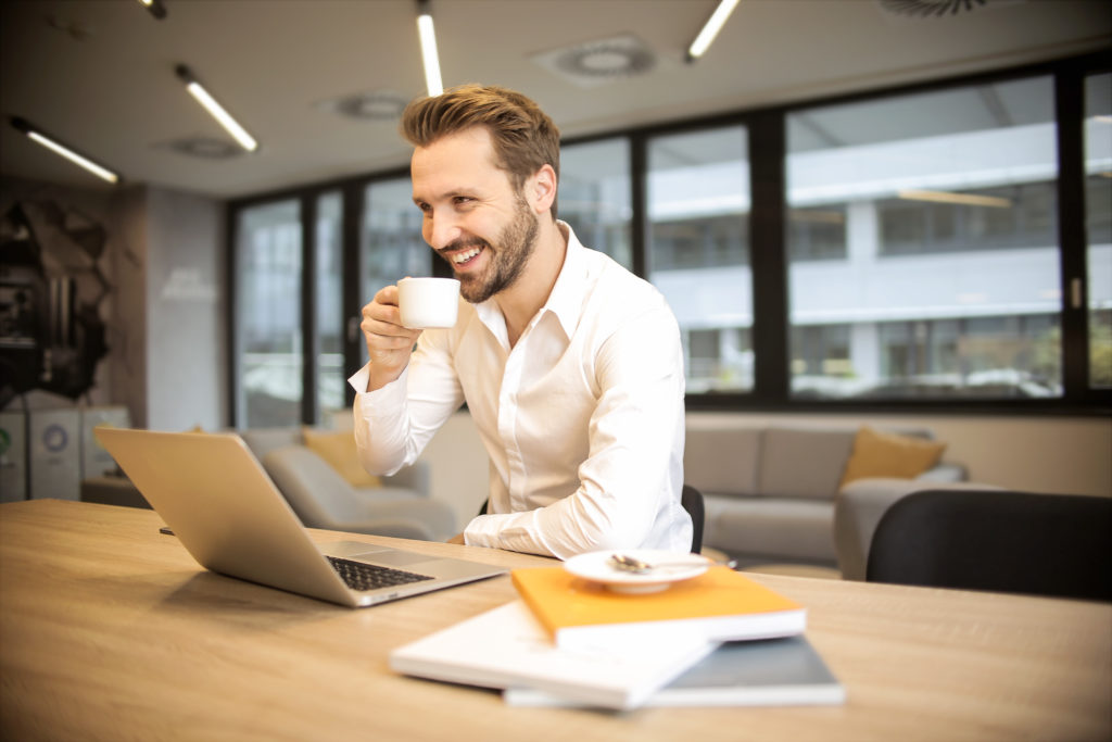 Man at desk with computer enjoying content filtering; Photo by Andrea Piacquadio from Pexels