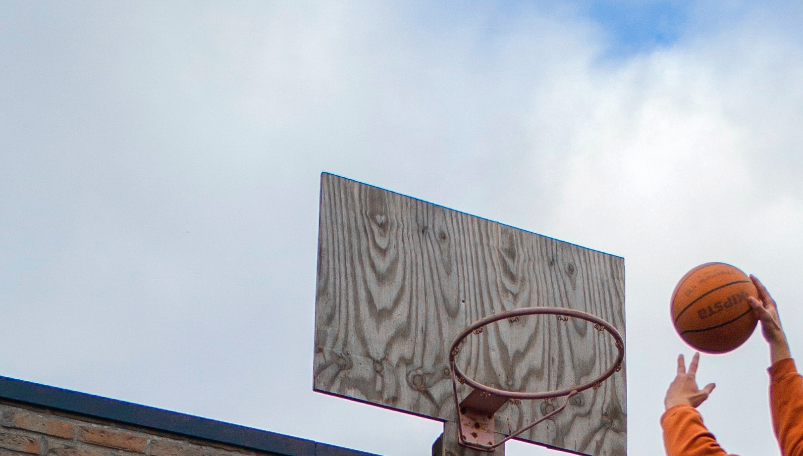 Image by brecht-deboosere slam dunking a basketball into a goal